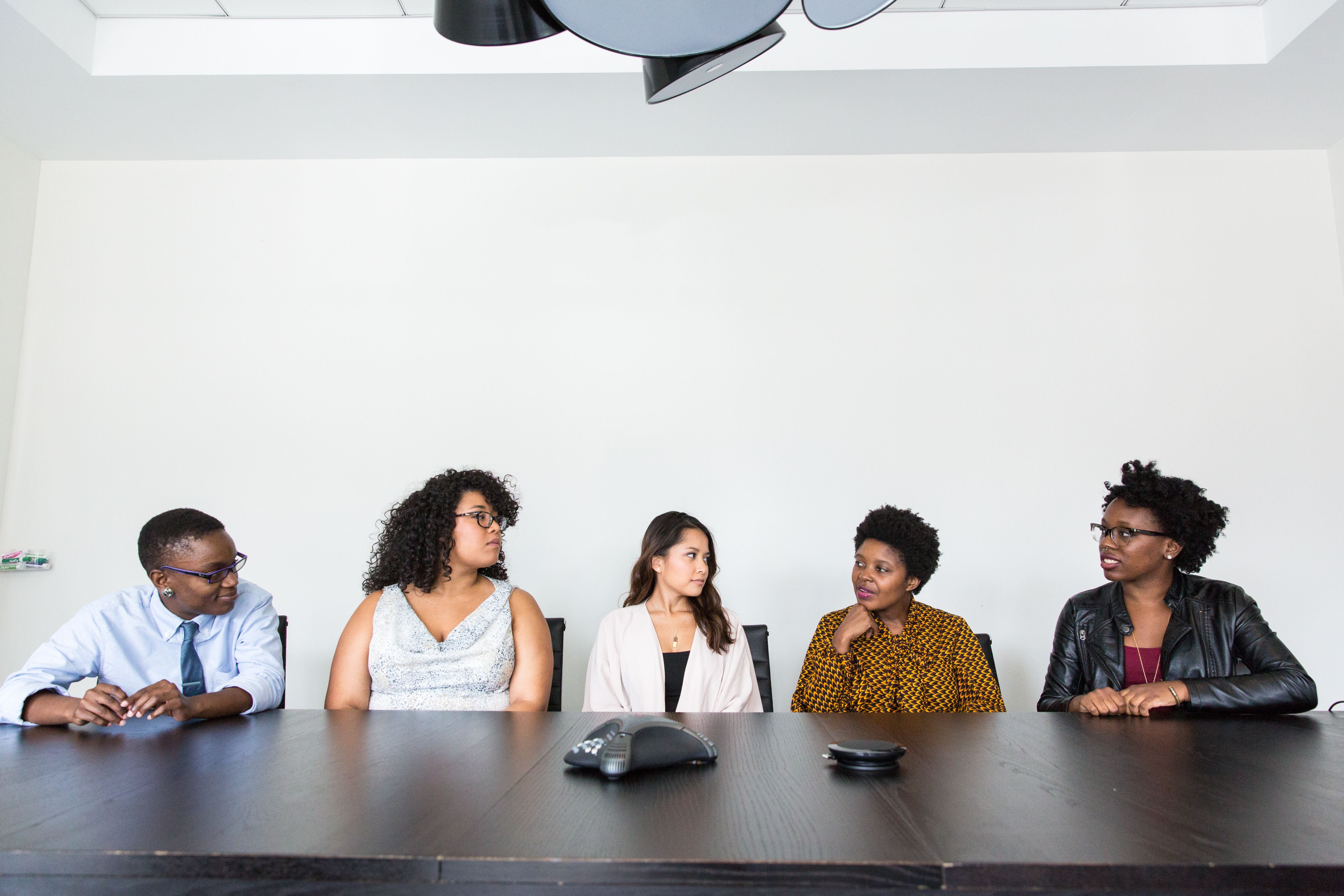Five colleagues meeting in an office to review a B2B search engine marketing campaign