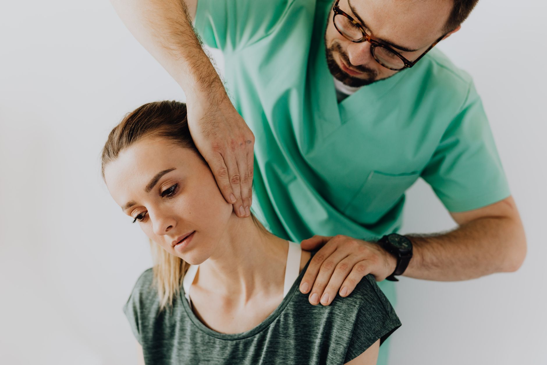 Chiropractor treating a patient's neck during an appointment, the kind of visit chiropractor Google Ads in Collingwood is built to book
