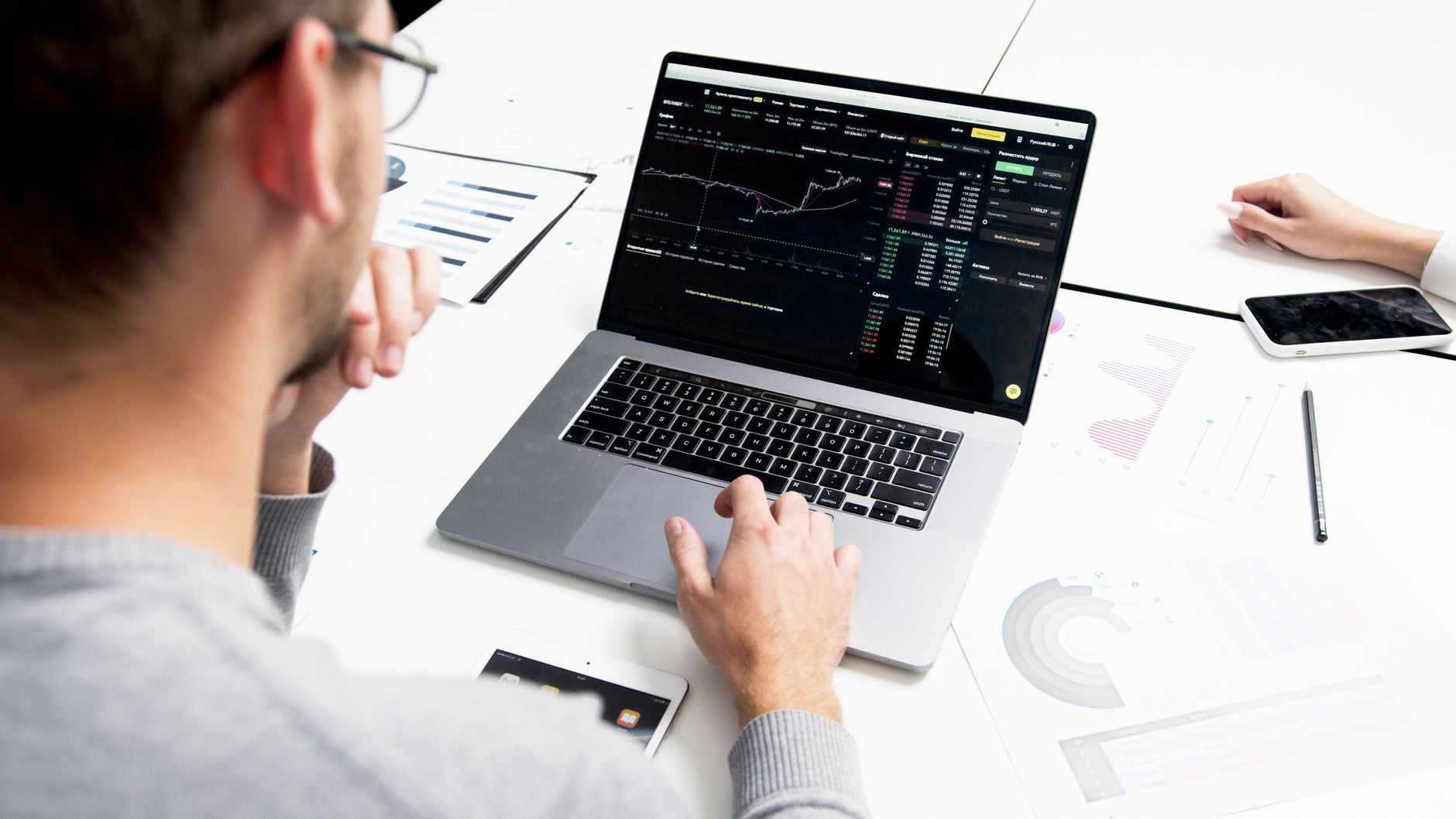 A person reviewing a sales chart on a laptop screen, tracking leads through pipeline stages
