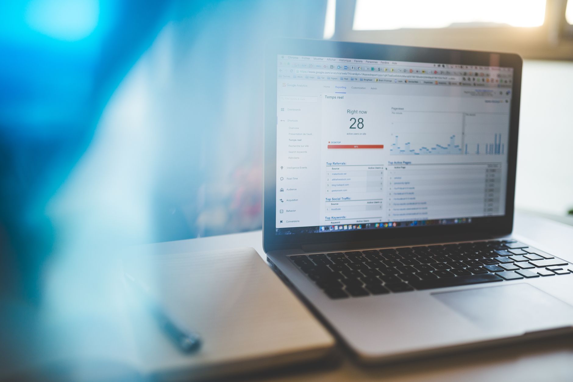 A laptop open on a wooden desk, the kind of screen where a small business owner would run a CRM for small business