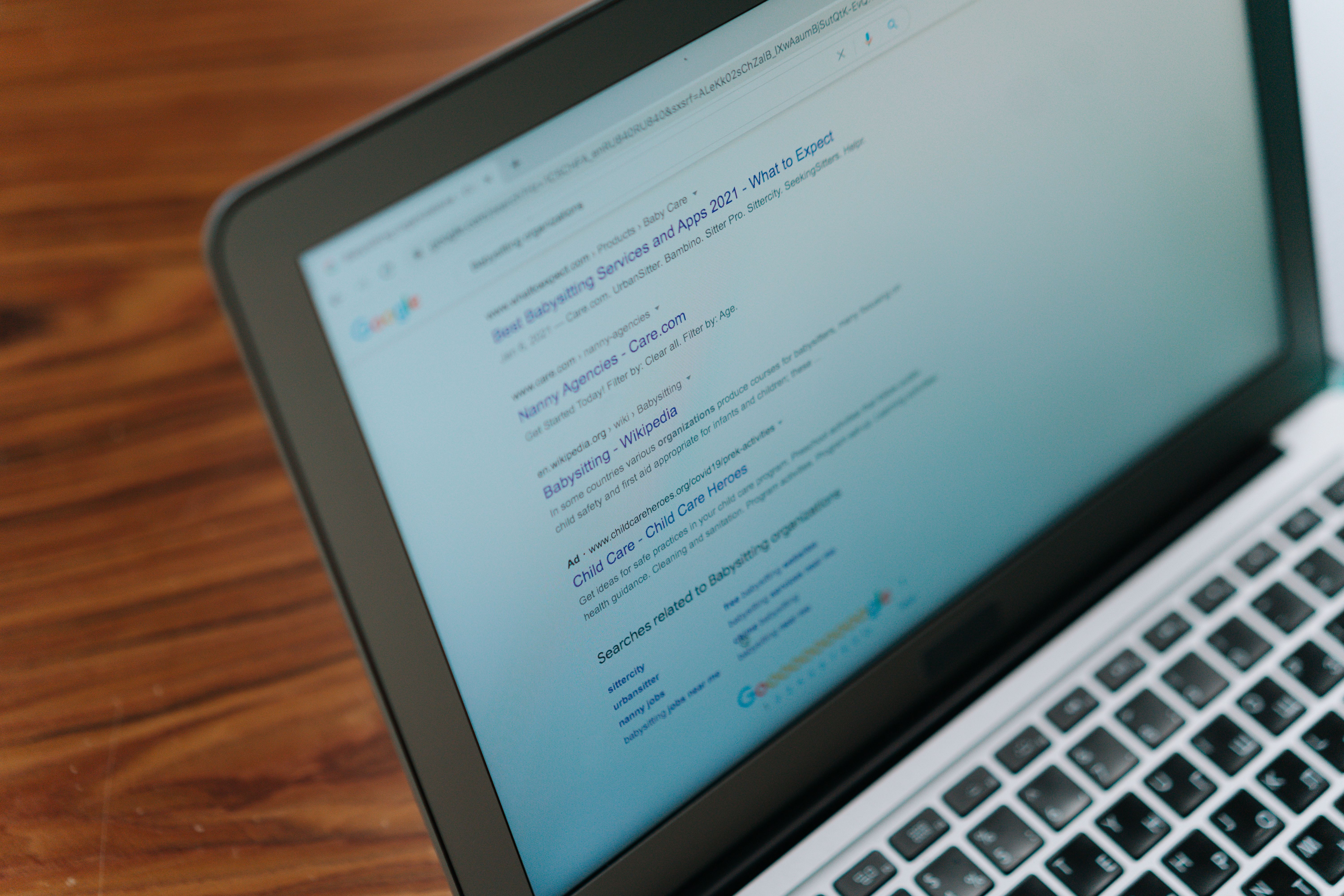 A laptop screen showing Google search results, illustrating how to build a negative keyword list for Google Ads to filter out irrelevant search queries