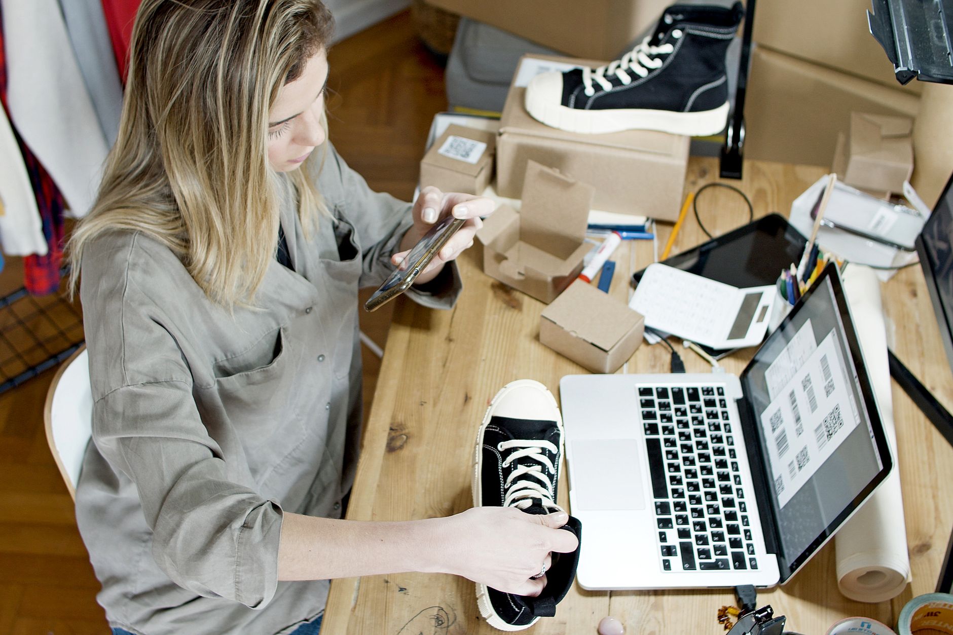 A small business owner checking her phone while working: the kind of moment to text a customer a Google review link