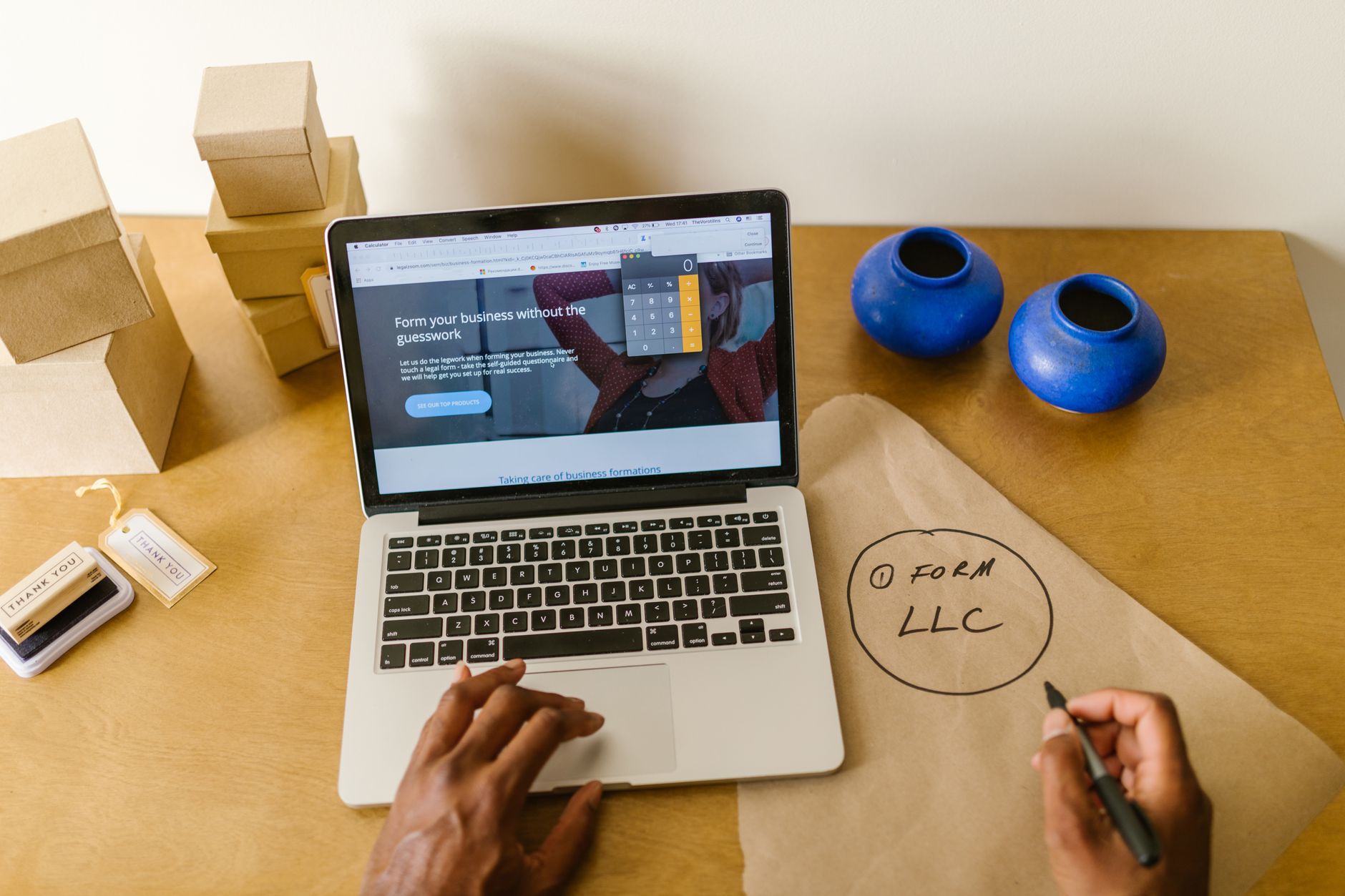 A small business owner reviewing ad performance on a laptop while planning how to structure a Google Ads account for a local service business