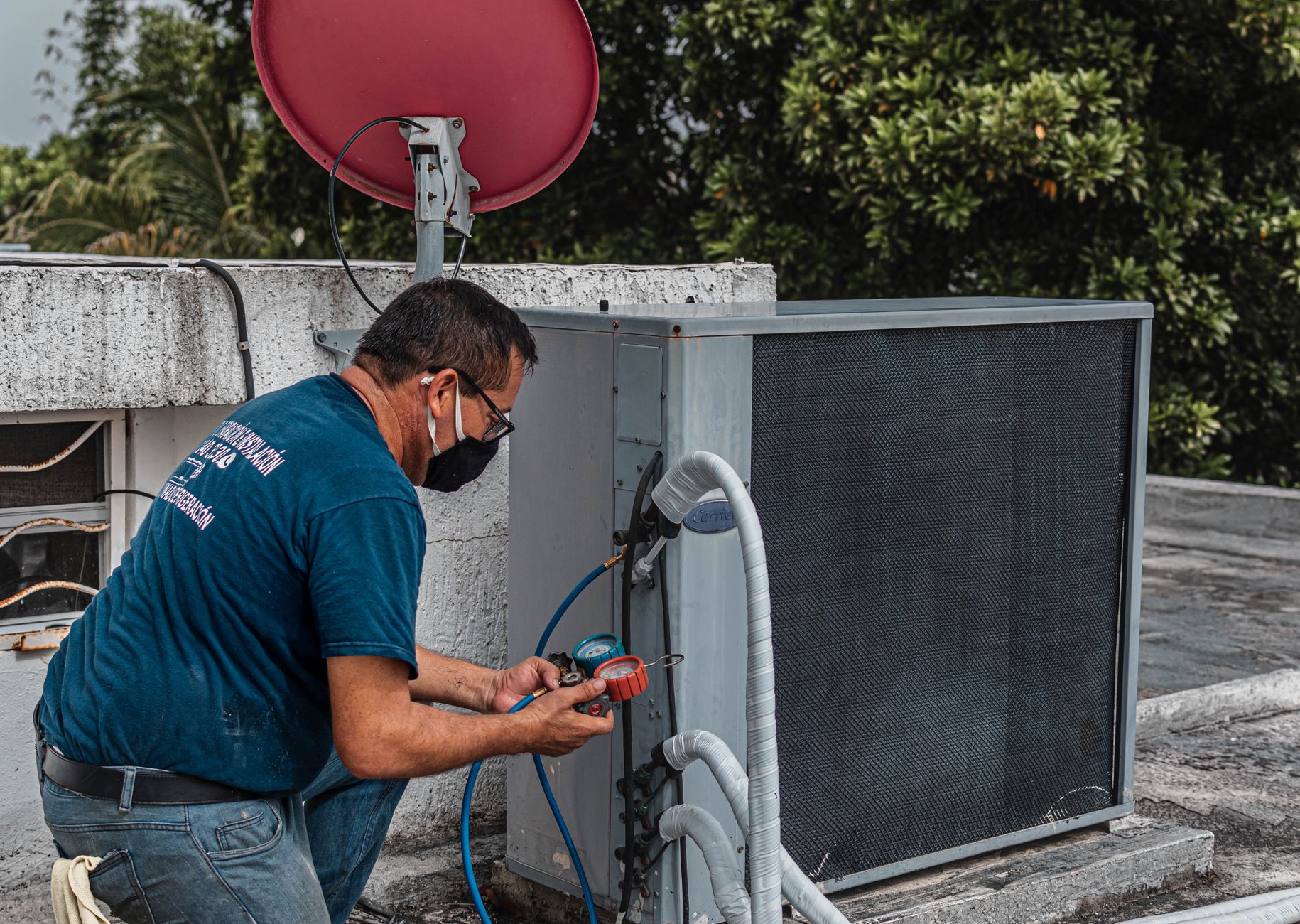 HVAC technician checking an air conditioning unit as part of an HVAC CRM systems service call in Alliston