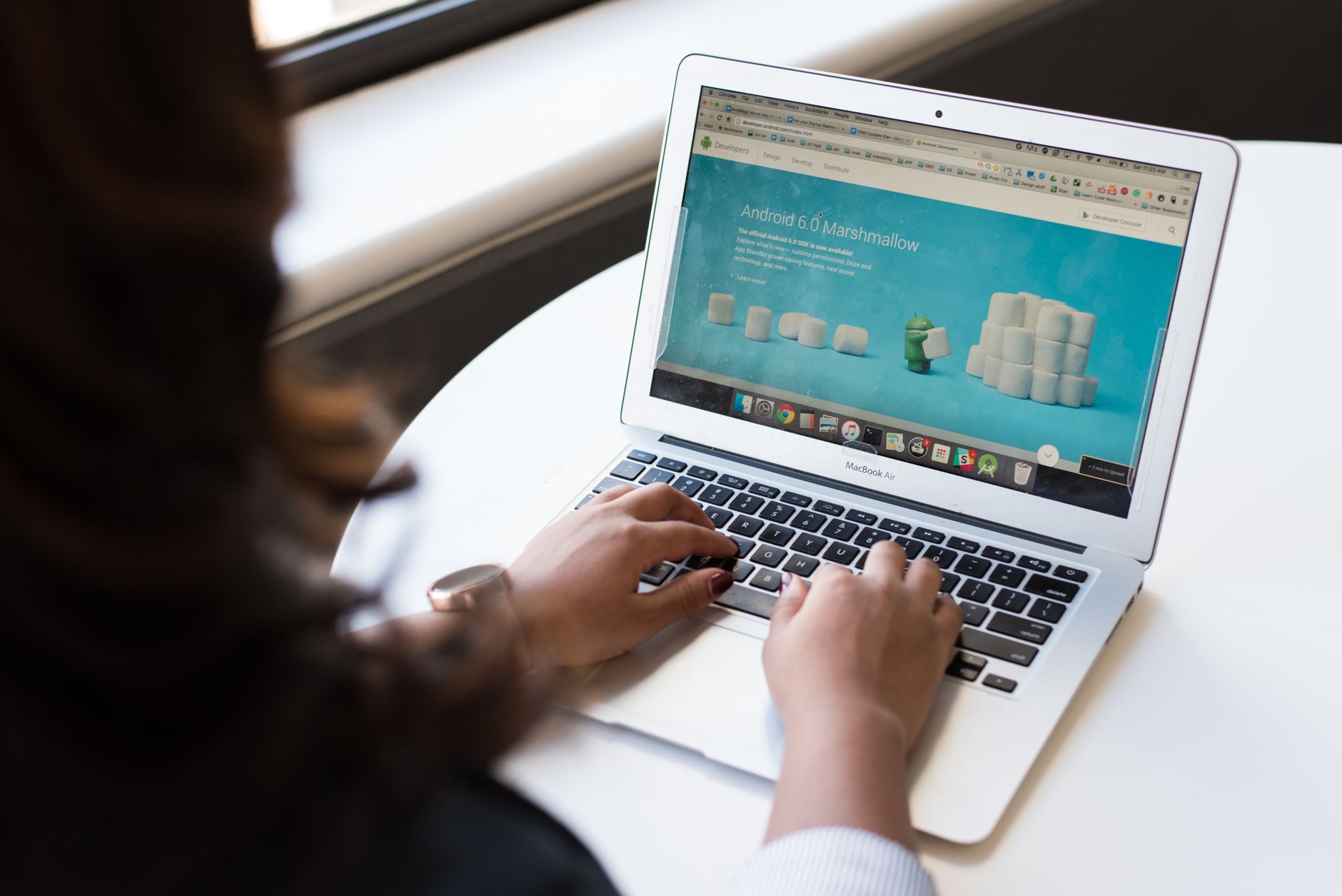 Hands typing on a laptop showing a website, an example of landing page best practices in action