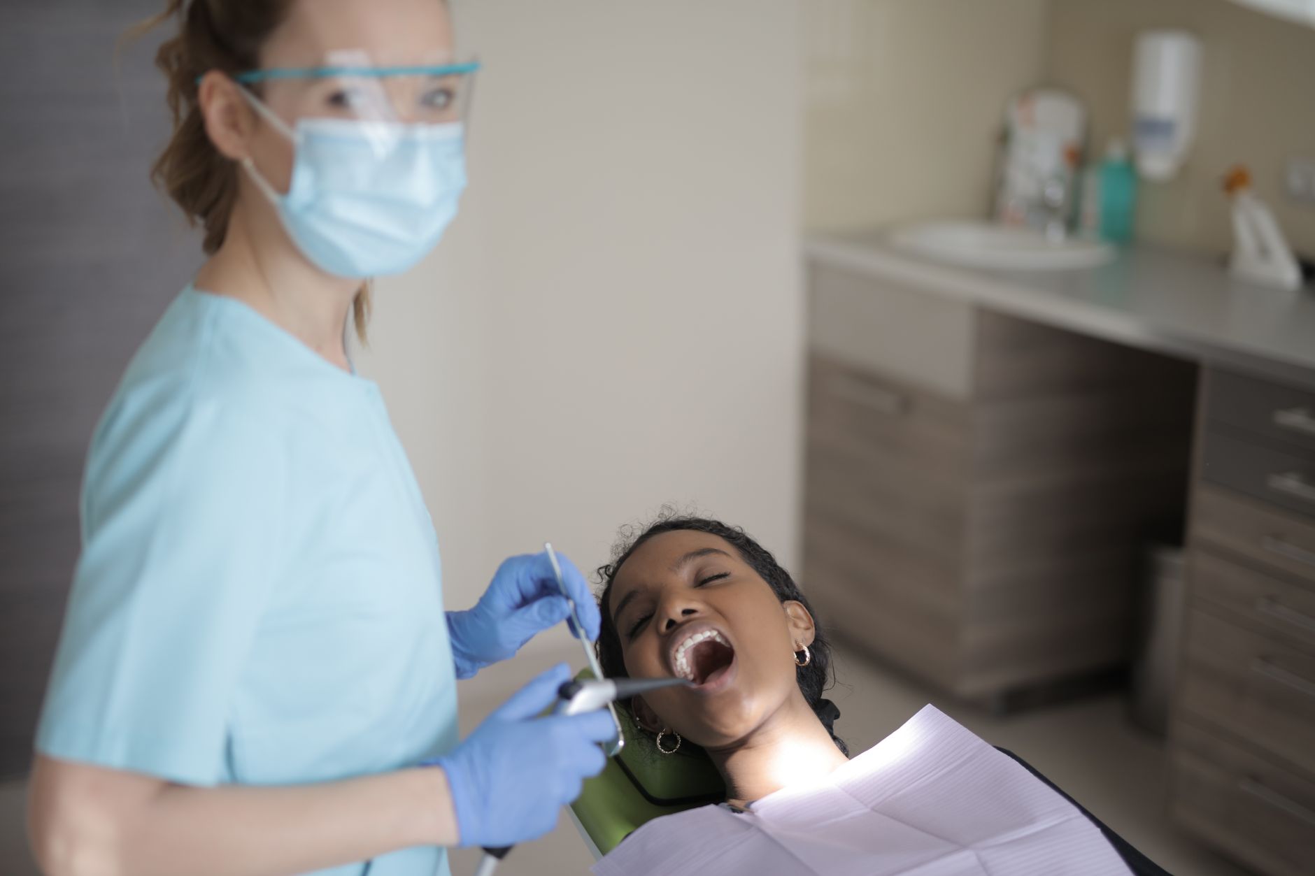 A dentist and patient in a treatment room, the kind of real photo that belongs on a dental practice's Google Business Profile
