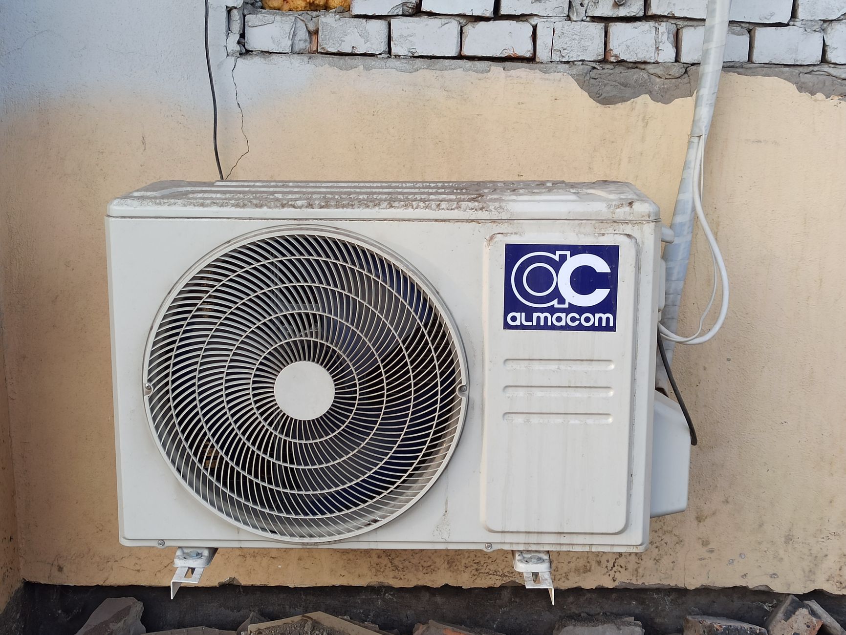 An outdoor air conditioning unit mounted on an exterior wall: the kind of finished-install photo that belongs on an HVAC company's Google Business Profile
