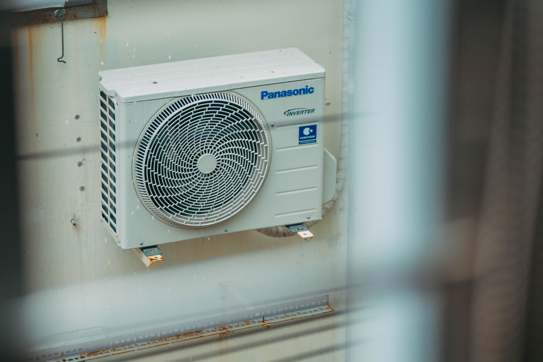 An air conditioning unit mounted on the exterior of a building, the kind of HVAC equipment local Thunder Bay technicians service and install