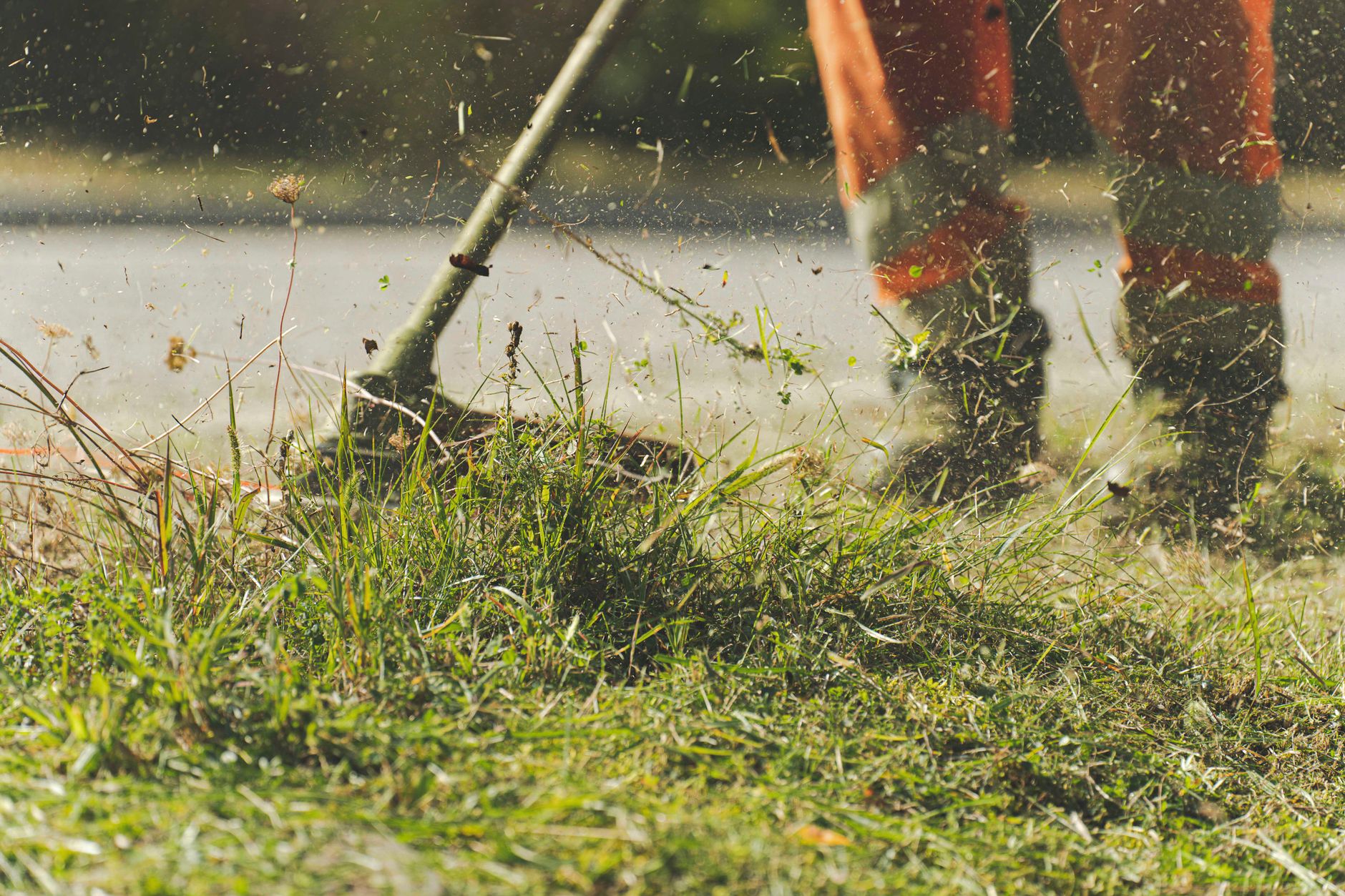 A landscaper using a string trimmer along the edge of a lawn, local SEO for landscapers in Bradford starts with a crew homeowners can actually find