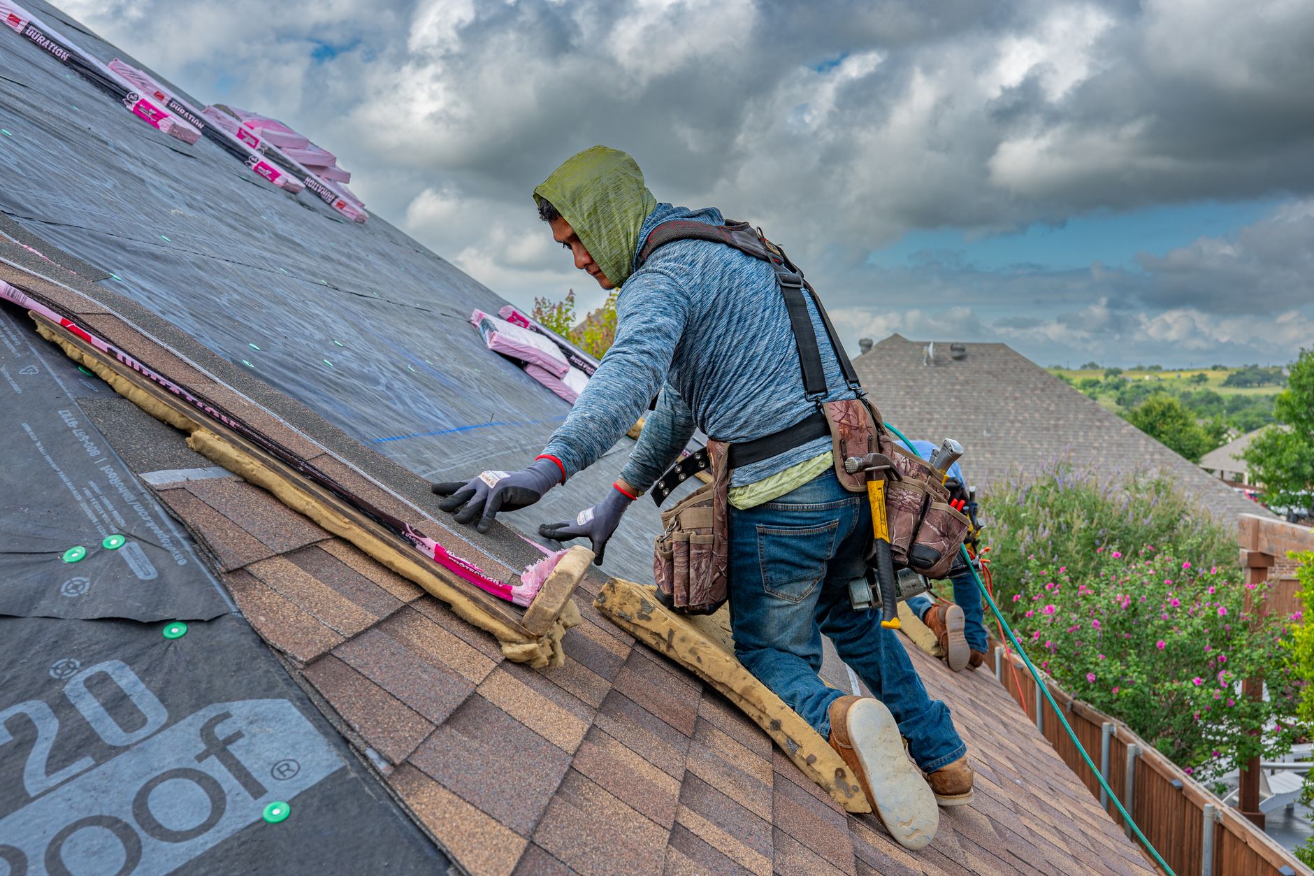 Roofer installing new shingles on a sunny day, the kind of finished-job photo worth posting weekly to Google Business Profile