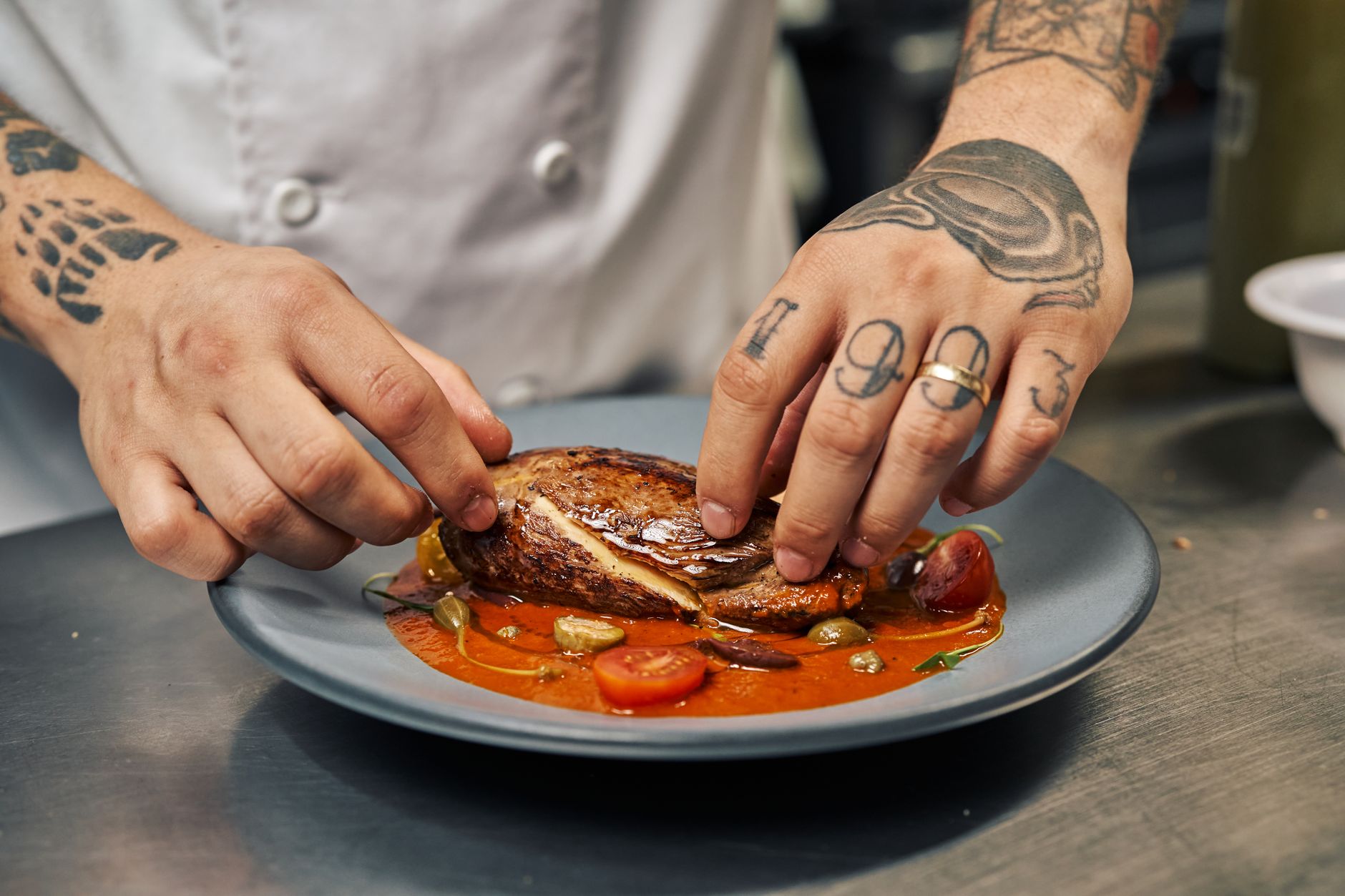 A chef plating a gourmet dish in a restaurant kitchen