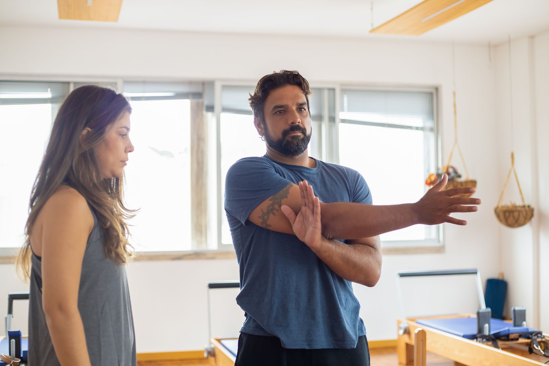 A physiotherapist supervising a patient's exercise routine in a treatment room