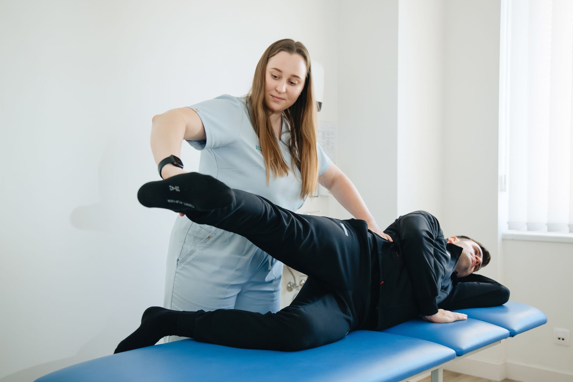 A physiotherapist massaging a patient's leg during a physiotherapy session, the kind of hands-on care local physiotherapy SEO services in Bradford should be helping patients find