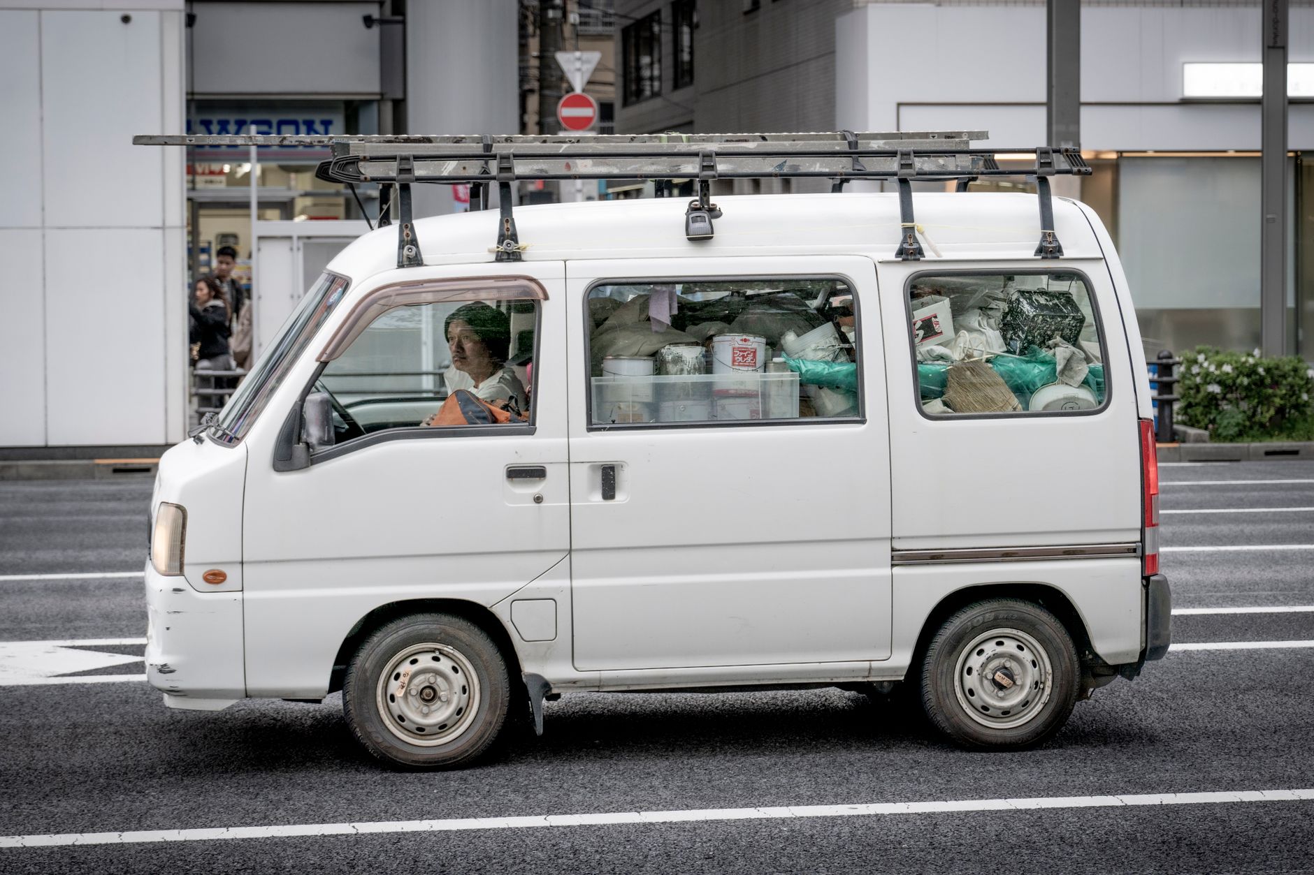 A white service van with a roof rack parked at the side of the road, ready for a same-day plumbing call
