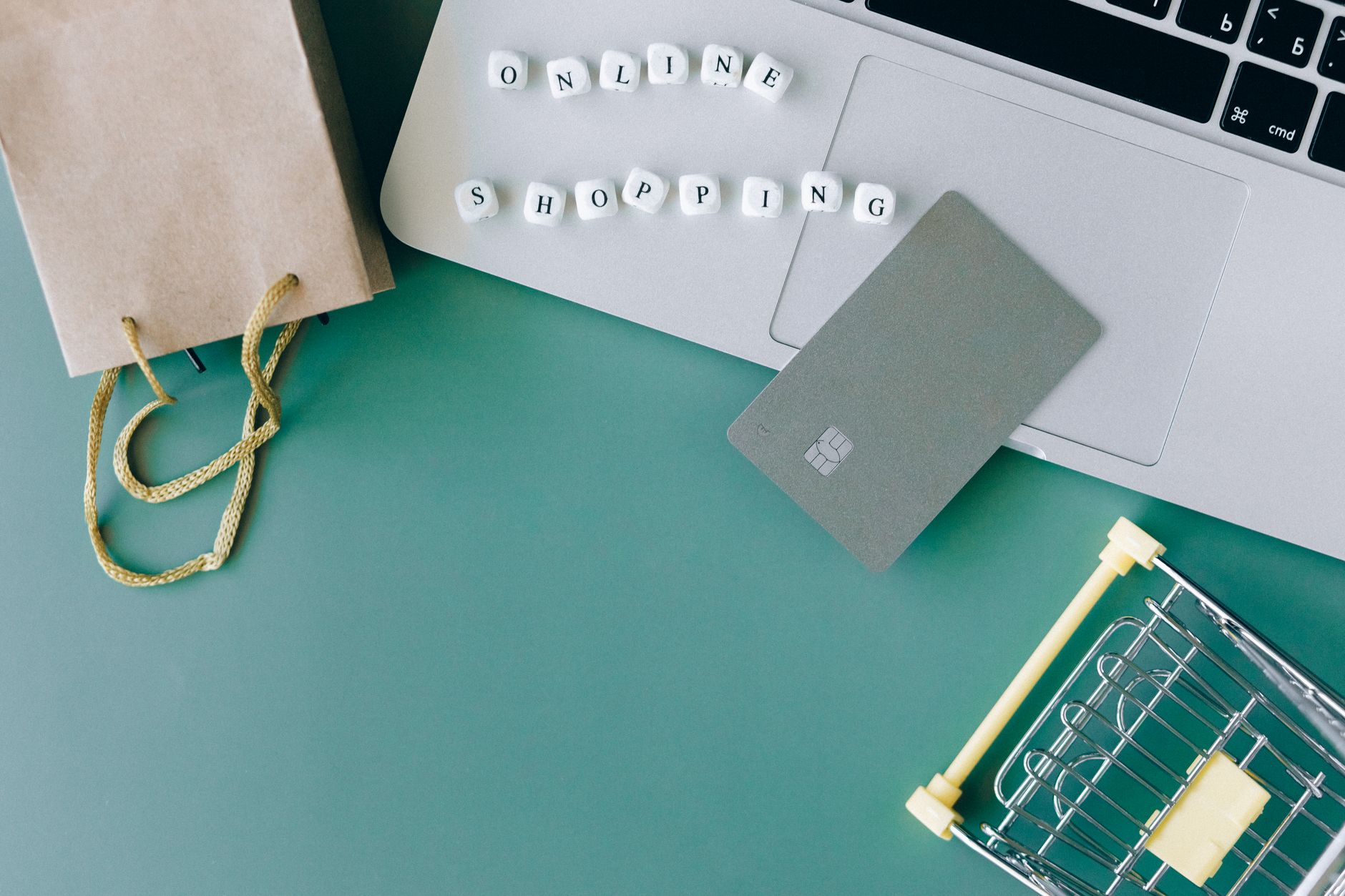 A bank card next to a laptop at online checkout, the kind of cart-abandonment moment a retargeting ads strategy is built to catch