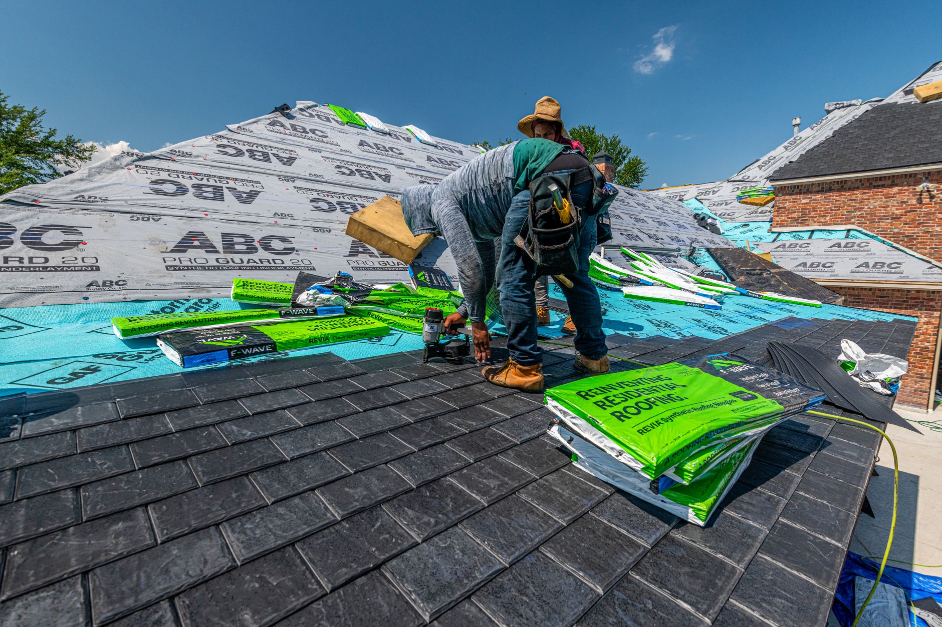 A roofer installing new shingles on a residential roof, the kind of job roofing Google Ads in Wasaga Beach are built to generate