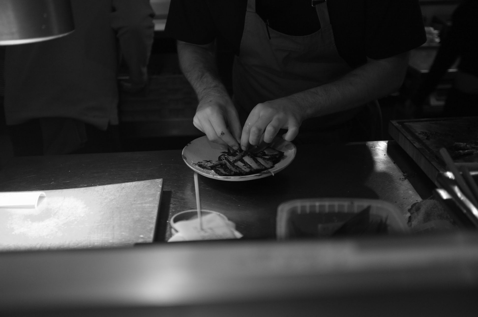 A chef plating a dish in a restaurant kitchen, the proof-of-food content that performs best on social media