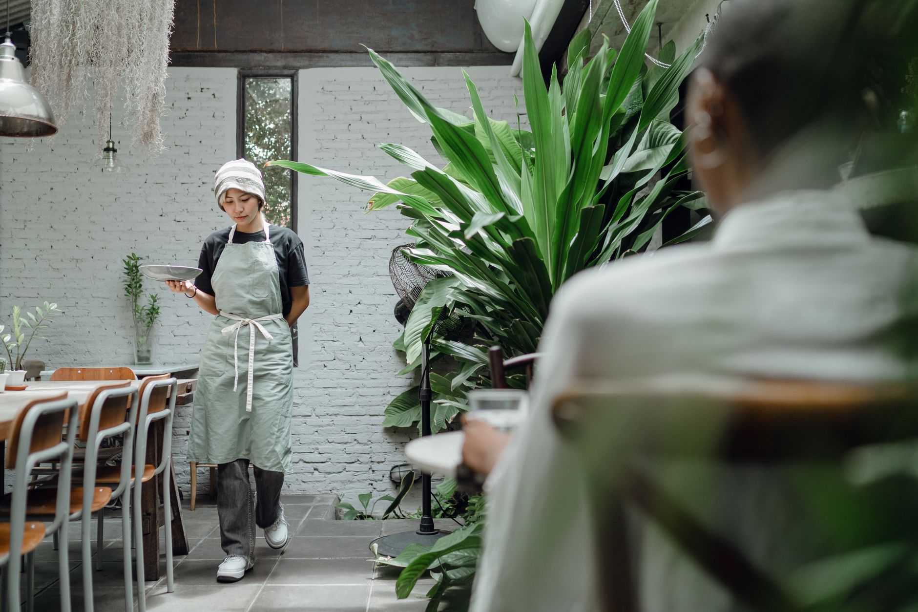 A server carrying a plate of food to a table, the kind of real moment social media marketing for restaurants in Barrie should be built around