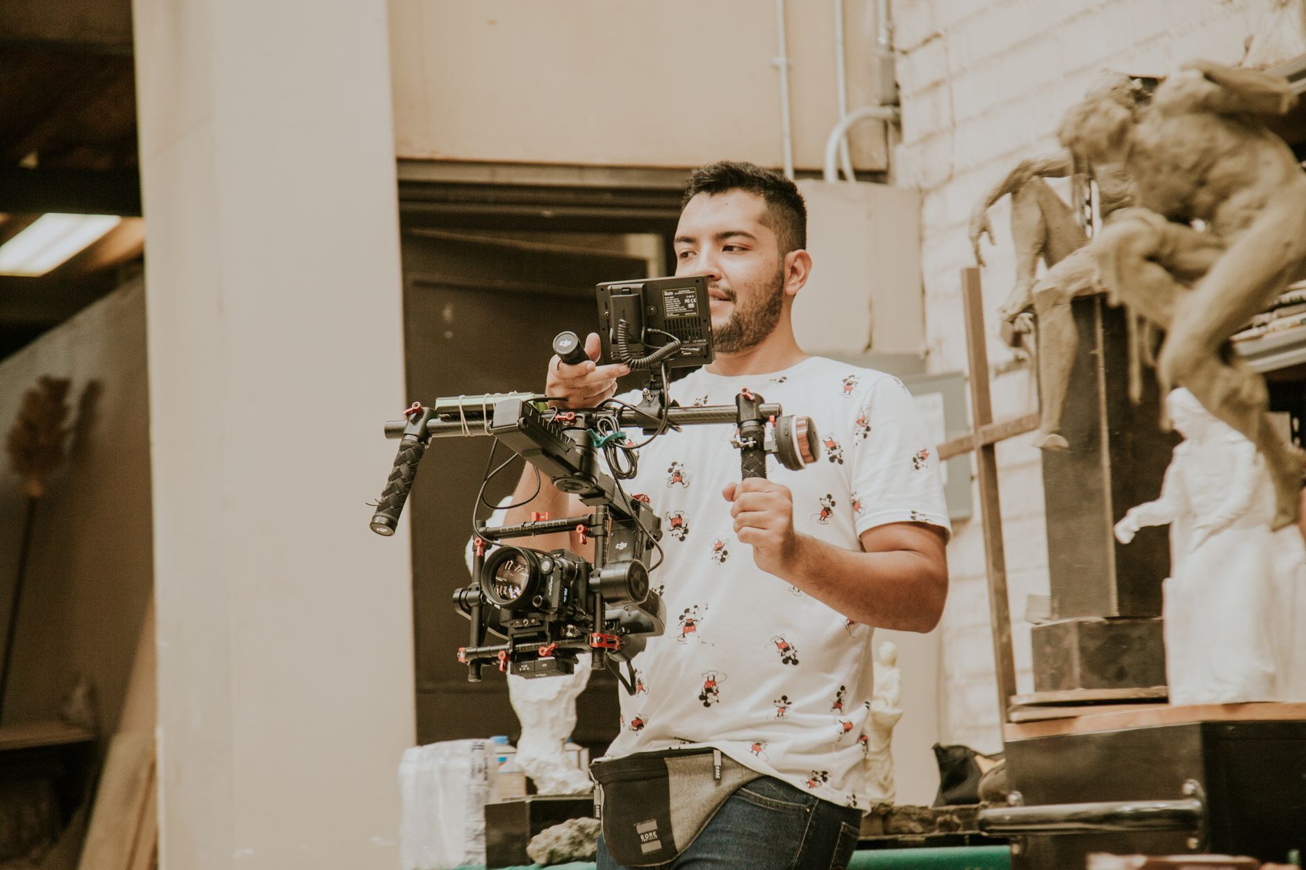 Videographer operating a gimbal-mounted cinema camera on location, the gear behind video marketing for contractors in Collingwood