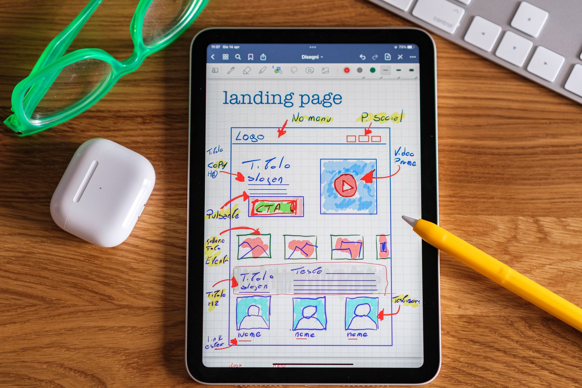 A landing page layout sketched on a tablet beside a stylus, planning a page to lift its conversion rate